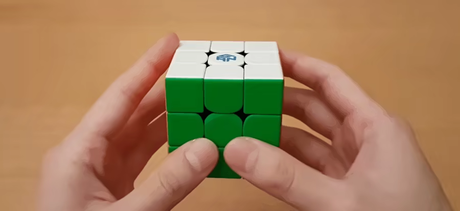 Holding a Rubik's cube showing front and bottom orientation